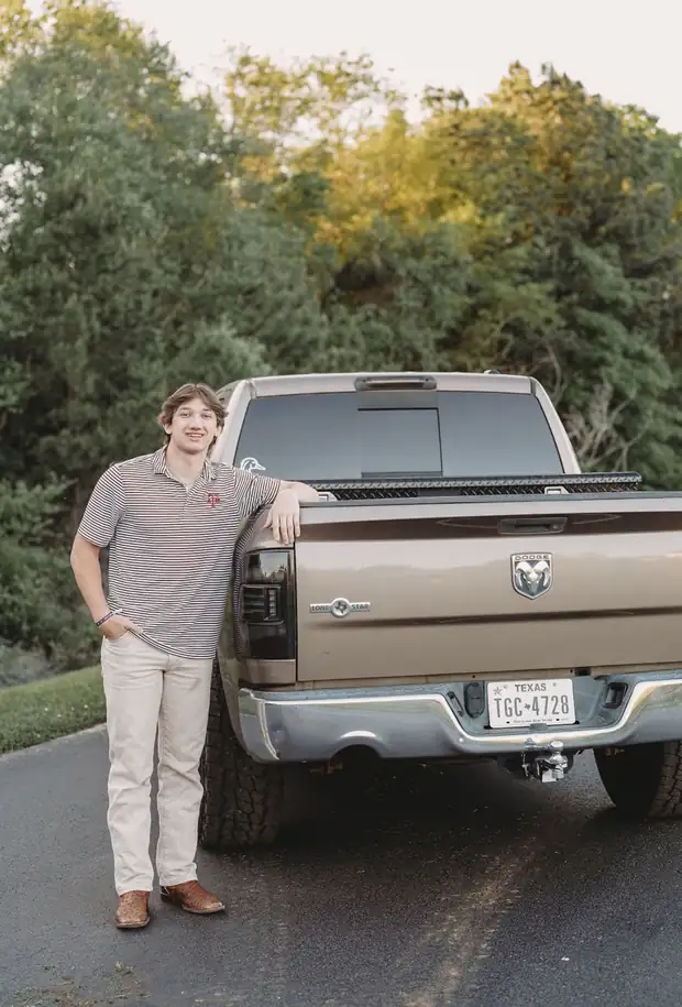Carson Riaz leaning on the tailgate of a pickup truck